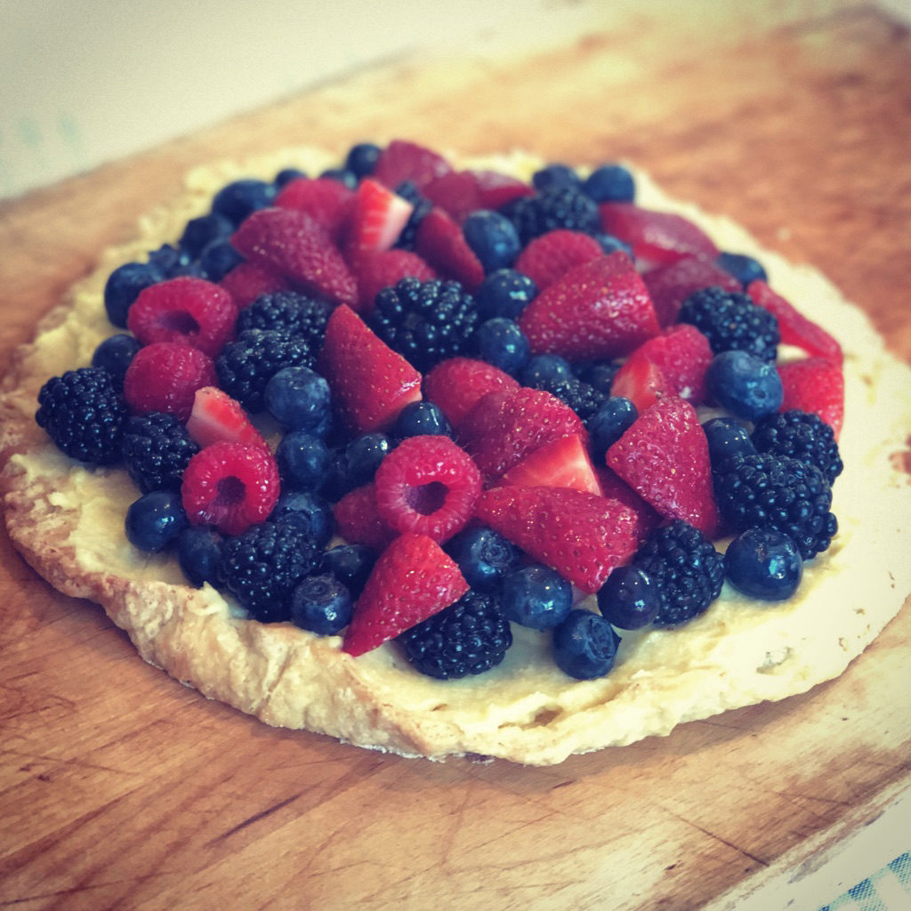 Free-Form Mixed Berry Tart on wood cutting board