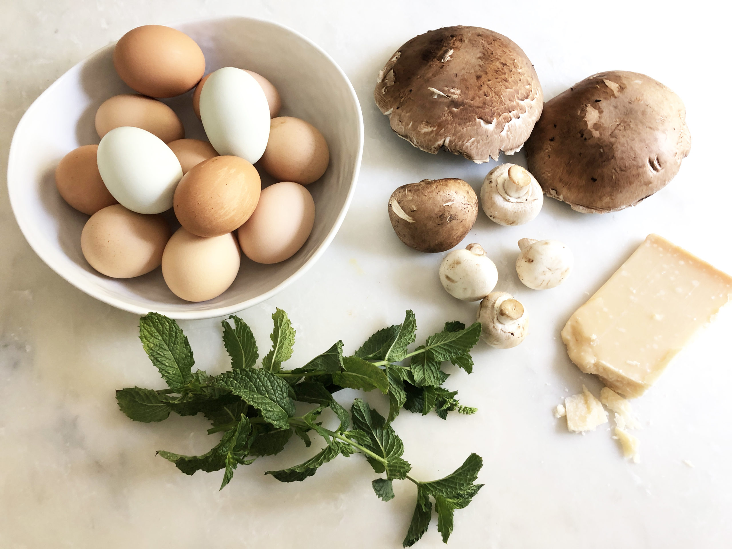Frittata ingredients: fresh eggs assorted mushrooms, shallots and fresh mint