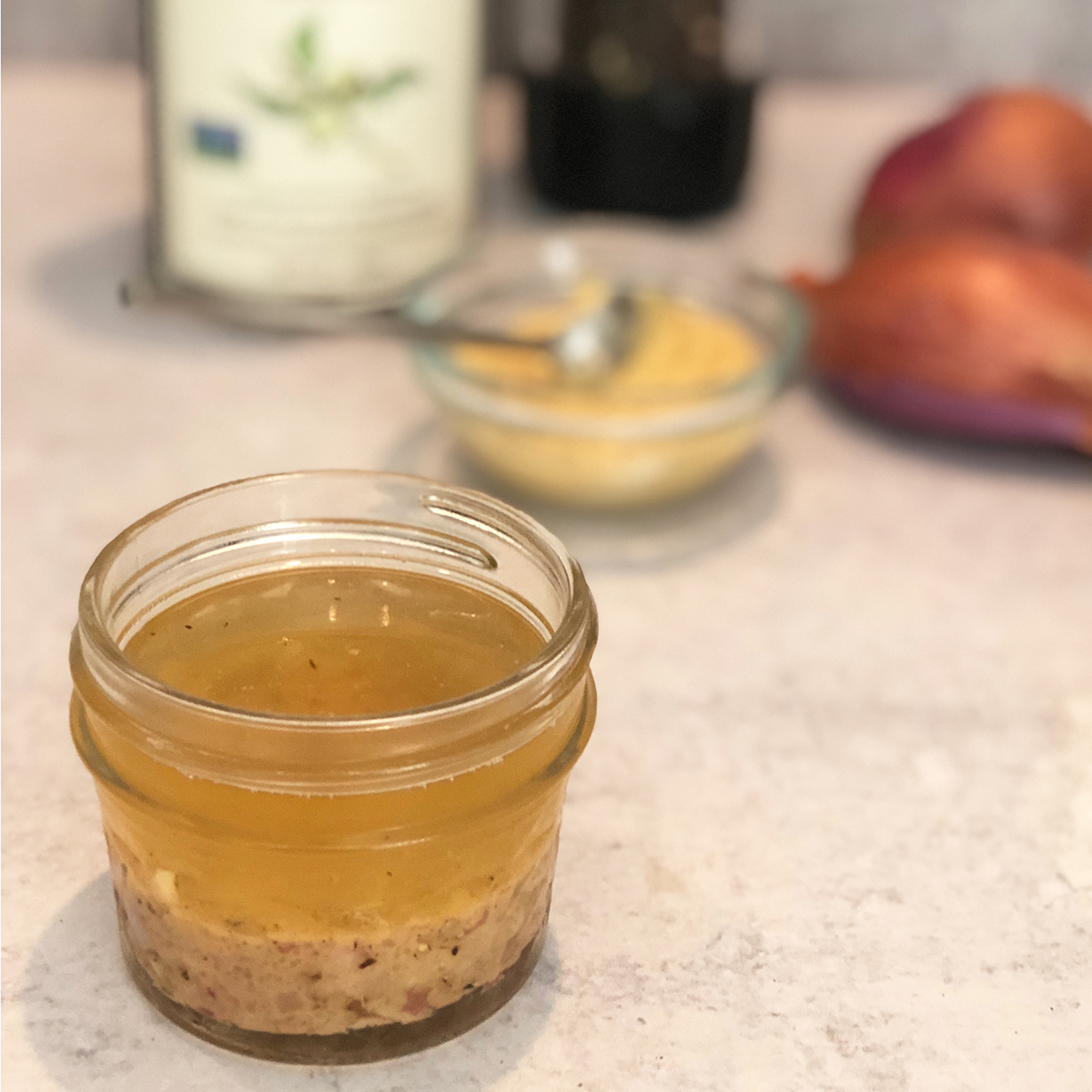 Shallot and Walnut Oil Vinaigrette with ingredients in background