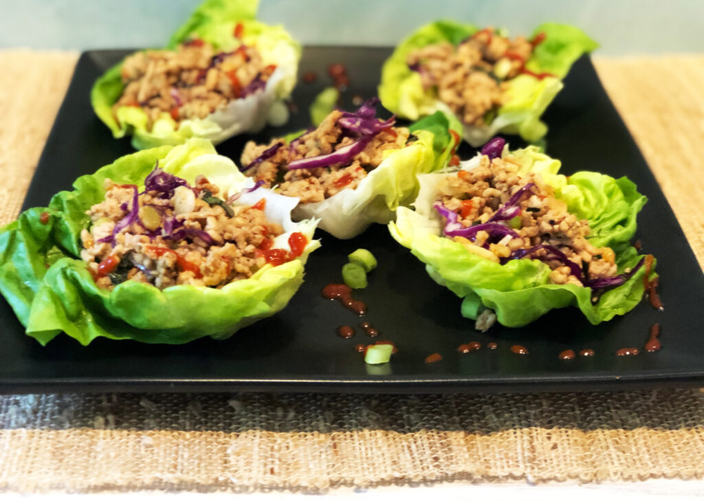 Asian Chicken Lettuce Wraps on a black serving plate